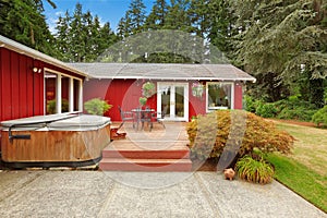 Bright red house with walkout deck and patio area