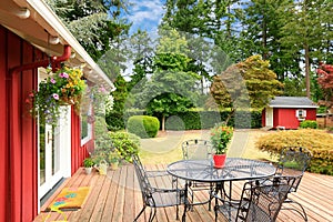 Bright red house with walkout deck and patio area