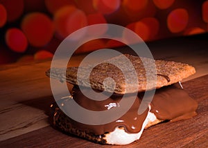 Bright red lights out of focus behind a large smore