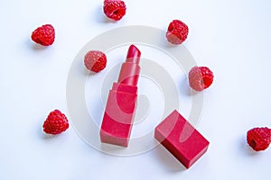 Bright red lipstick and ripe juicy raspberries