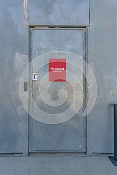 Bright red No Access signage on a shiny door at Waterloo Park Austin Texas photo