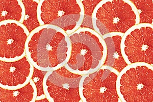 Bright red-orange background of round grapefruit lobules. Drawing for the surface of wallpaper, paper, advertising, decor