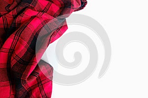 Bright red plaid wrinkled shirt on a white background. Environment for working or studying from home. Empty surface surrounded by