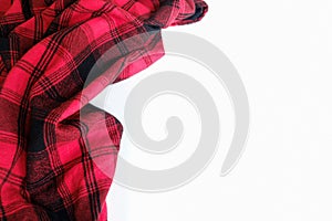 Bright red plaid wrinkled shirt on a white background. Environment for working or studying from home. Empty surface surrounded by