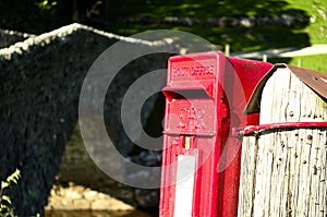 Bright red postbox in the countryside