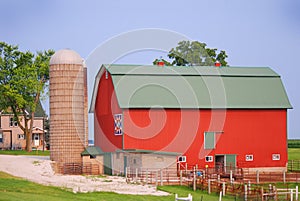 A bright red quilt barn with a silo in rural Wisconsin.