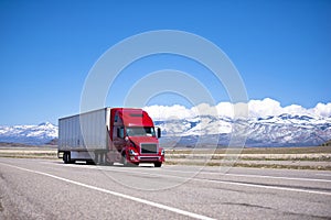 Bright red semi truck modern transportation on spectacular highway