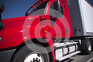 Bright red semi truck with trailer in close up view