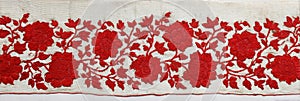 Bright Red Sindoor Trail on White Silk Cloth Showcasing Intricate Floral Embroidery Design photo