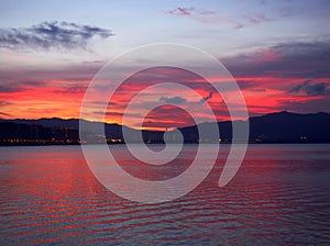 Bright Red Sunset Glow on Seashore