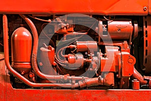 Bright red tractor engine closeup