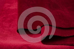 Bright red velour textile sample. Fabric texture background