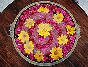 Bright red and yellow coloured flowers arranged for display in Lalitha Mahal Palace, Mysore