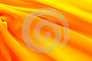 Bright red yellow fabric with diagonal folds