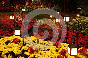 The bright red and yellow flowers decorated around ground light poles