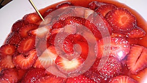 Bright red yummy strawberries inside sugar water