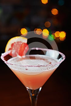 Bright refreshing cocktails on a table in a restaurant with creative decoration of red orange slices on a wooden table in a bar or