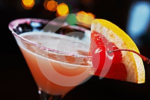 Bright refreshing cocktails on a table in a restaurant with creative decoration of red orange slices on a wooden table in a bar