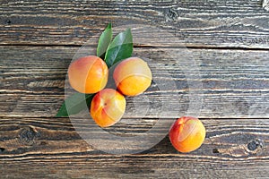 Bright ripe apricots lie on a wooden table
