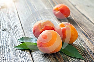 Bright ripe apricots lie on a wooden table