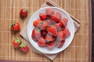 Bright, ripe, delicious strawberries in a white plate