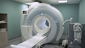 Bright room with modern CT scan machine