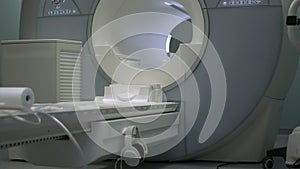 Bright room with modern CT scan machine