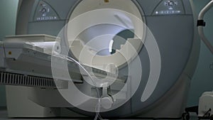 Bright room with modern CT scan machine