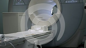 Bright room with modern CT scan machine