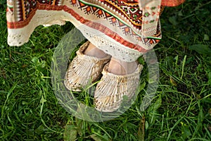 Bright Russian bast shoes with a Russian-folk sundress