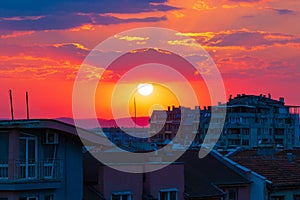 Bright setting sun over buildings rooftops Varna Bulgaria