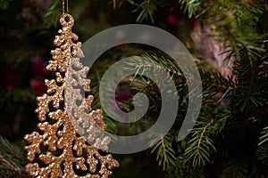 Bright and shiny decorations for Christmas and New Year hang on a green spruce