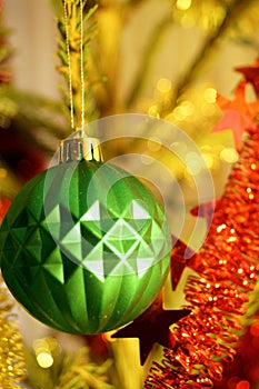 Bright and shiny decorations for Christmas and New Year hang on a green spruce