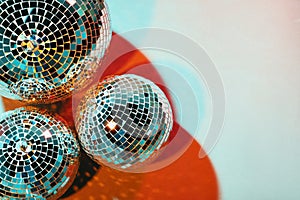 Bright shiny disco balls on color background, top view. Space for text