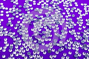 Bright and Shiny Precious Rhinestone Swarovski crystal color on a purple background.