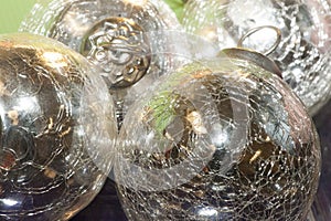 Bright, shiny, silver-colored metallic balls are viewed close-up.