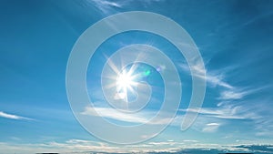 Bright shiny Sun with rays of blue sky, panning video with moving lens flare