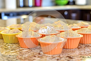 bright silicone molds filled with glutenfree muffin mixture on a countertop