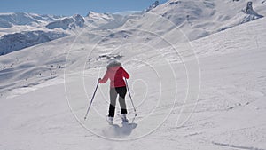 Bright Skier Slides Down Snowy Slope In Mountains In Winter On Skis