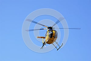 Yellow tourist helicopter in midair photo