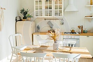 Bright spacious dining room with wooden big table