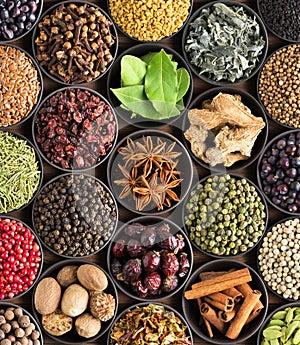 Bright spices and herbs in cups, top view. background for packi