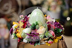 Bright spring composition with multicolor flowers and big egg candle