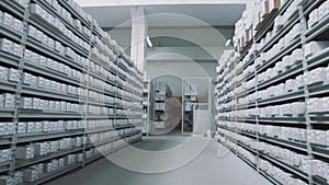 Bright storehouse shelves full of white boxes with numbers markings