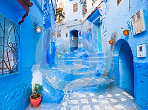 Bright street with blue walls and pretty arches in Chefchaouen, Morocco