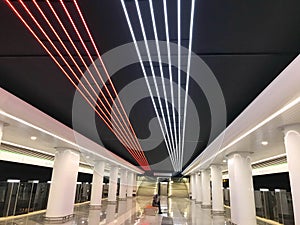 Bright strips of LEDs on the ceiling. blue and white stripes, illumination. decoration of the ceiling in the subway. around white