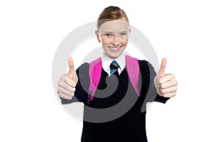 Bright student showing thumbs up sign