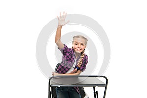 She is a bright student. Small girl student raising hand isolated on white. Little student reciting lesson in class