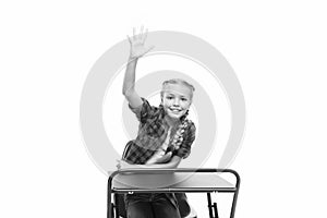 She is a bright student. Small girl student raising hand isolated on white. Little student reciting lesson in class