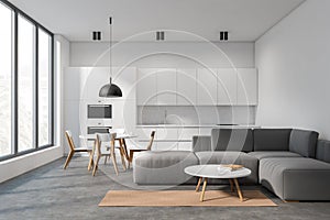 Bright studio room interior with panoramic window, sofa